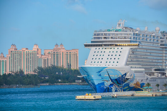 Norwegian Escape cruise ship in port in Nassau Bahamas with Atlantis resort in background