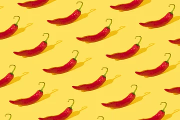 Rolgordijnen Red hot chili peppers pattern on trendy yellow background. Minimal food concept. © Bojan Zec