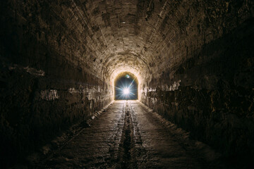 Fototapeta na wymiar Dark and creepy old historical vaulted underground road tunnel