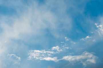 fluffy gentle clouds slowly and hopelessly float across the endless sea of blue sky. Clear blue sky after the raging elements and storms.