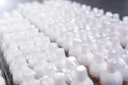 cosmetics production - industry - plastic packaging - white plastic bottles