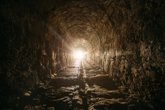 Fototapeta Dark and creepy old historical vaulted underground road tunnel