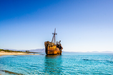 Rusty and abandoned shipwreck on a coastline near Gythio in Lakonia, Peloponnese Greece