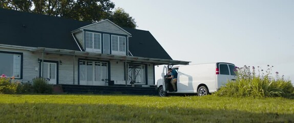 TACKING Adult Mature Caucasian female signing documents with handyman general worker in front of her house. White car with copy space. Shot with 2x anamorphic lens