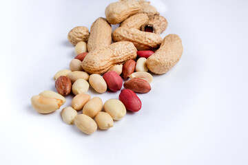 Fototapeta na wymiar Peeled peanuts and peanut pod isolated on white background.