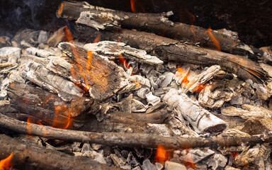 Bonfire. Smoldering firewood close-up. Cooking food in the field.