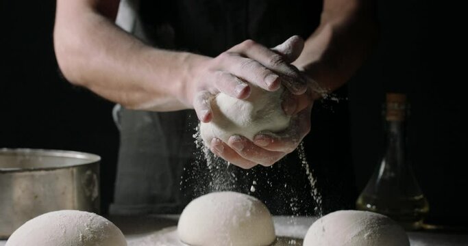 Close up shot of bakery worker carefuly forming loafs of bread. Baker making dough, using natural ingredients. food and drink 4k footage