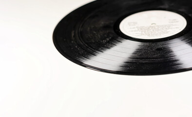 an old and dusty black vinyl record isolated on a white background