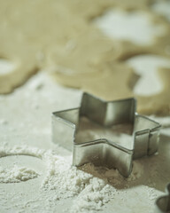 Cookie mold, with rolled dough and flour on the table.
