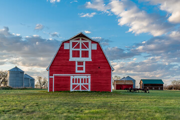 Vintage red barn in a farmyard on the prairies in Saskatchewan  © Nancy Anderson