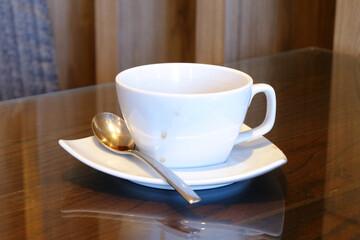 White ceramic glass with stain of coffee on wood table