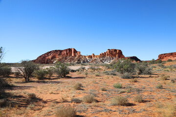 Amazing Rainbow Valley in Northern Territory, Australia, just outisde Alice Springs.  Beautiful red and orange rock formation with blue sky and orange sands
