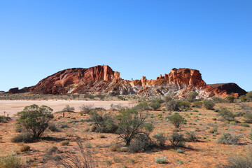 Amazing Rainbow Valley in Northern Territory, Australia, just outisde Alice Springs.  Beautiful red and orange rock formation with blue sky and orange sands