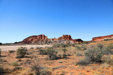 Amazing Rainbow Valley in Northern Territory, Australia, just outisde Alice Springs.  Beautiful red and orange rock formation with blue sky and orange sands