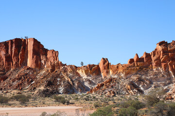 Amazing Rainbow Valley in Northern Territory, Australia, just outisde Alice Springs.  Beautiful red and orange rock formation with blue sky and orange sands