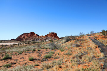 Amazing Rainbow Valley in Northern Territory, Australia, just outisde Alice Springs.  Beautiful red and orange rock formation with blue sky and orange sands