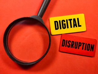 Business concept.Text DIGITAL DISRUPTION writing on colored wooden board with magnifying glass on a...