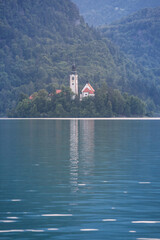 Fototapeta premium Panorama of the Blejsko ostrvo, or bled island, on Bled lake or Blejsko Jezero, with assumption of Maria church, or cerkev marijinega vnebovzetja. it's a catholic church in Slovenia