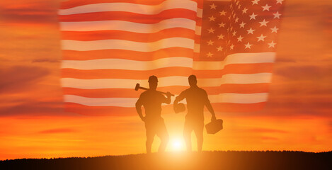 Worker on the USA flag background . Labor day holiday concept.