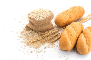 Delicious organic bread with ears of wheat isolated on white background - top view
