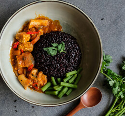 Homemade vegetarian meals. Vegan Massaman Curry with Black Rice. Delicious and healthy ideal for weight watcher, on diet or light eater or people who observed going meatless in a day or two per week.