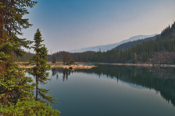 Fototapeta na wymiar Symmetry mirror images in Horseshoe lake. Jasper AB Canada 