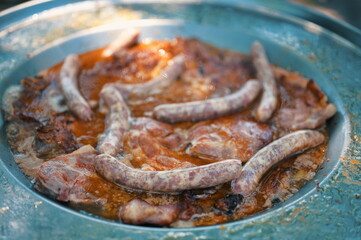 High angle view of pork meat on the barbecue plate