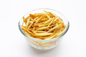 Sliced finger root in glass bowl on white background.