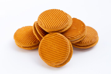Custard cream sandwich biscuits on white background.