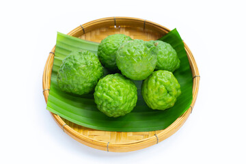 Bergamot kaffir lime herb fresh fruit in bamboo basket on white background.