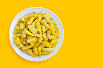 Preserved bamboo shoot in white plateon yellow background.