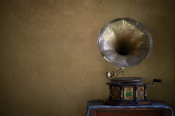 Golden gramophone with disk on wooden box