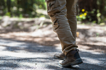 Close up of man shoes trekking boot walking on the path in mountain outdoor leisure activity - equipment and active free lifestyle people concept