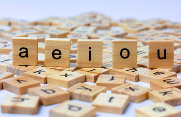 English alphabet made of square wooden tiles with the English alphabet scattered on white background. The concept of thinking development,grammar.