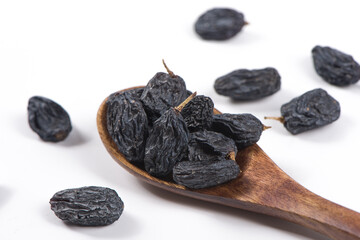 Dried black raisins isolated on white background