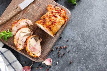 Chicken roll and vegetables on a cutting board on the table. Copy space