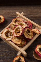 Dried hawthorn slices on wooden  background