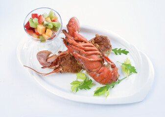 western baked whole cheese fresh lobster seafood with fruit cocktail salad in white background asian halal seafood menu