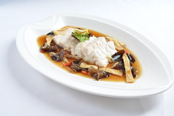 steamed slices grouper fish fillet with Chinese herbal fungus miso sauce seafood in white background asian halal seafood menu