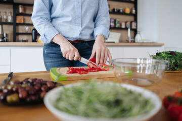 Closeup of human hands cooking vegetables salad in kitchen