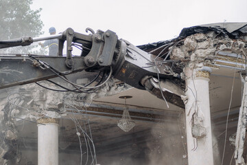 The excavator demolishes the building