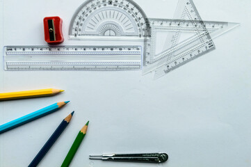 Geometric Measuring tools, Drawing items and mathematical instruments placed on white paper sheet....