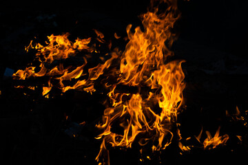 Fototapeta na wymiar fire in the fireplace at night. fire with dark background