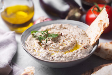 Baba ganoush with stuck pita bread poured with olive oil