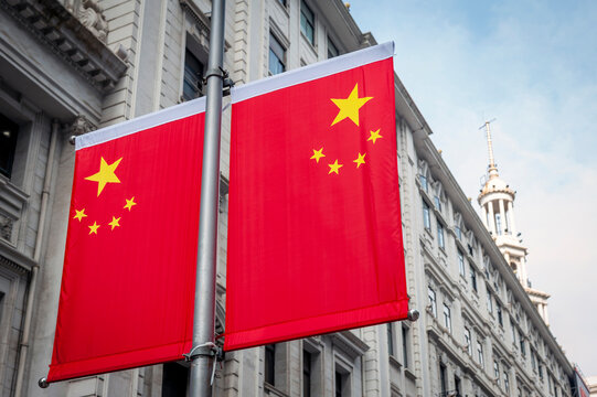 National flag of People's Republic of China decorated in front of an old building on Nanjing Road in downtown Shanghai