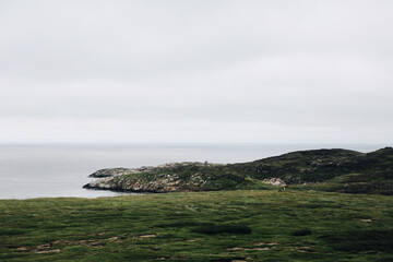 Grense Jakobselv. Finnmark county. Arctic Northern Norway coastal landscapes. Top view of the Barents Sea, mountains and fjords in the fog