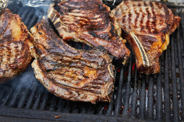 Grilled beef steaks with grill smoke. BBQ party