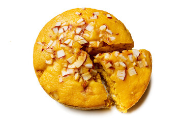 A large-sized ripe palmyra palm fruit cake sprinkled with coconut pieces. Steamed palmyra palm cake in isolated white background.