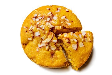 A large-sized ripe palmyra palm fruit cake sprinkled with coconut pieces. Steamed palmyra palm cake in isolated white background.