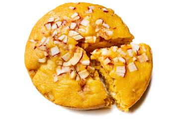 A large-sized ripe palmyra palm fruit cake sprinkled with coconut pieces. Steamed palmyra palm cake in isolated white background.